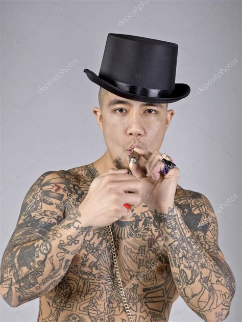 A man with tattoo smoking a cigarette — Stock Photo © kozzi2 #20335119