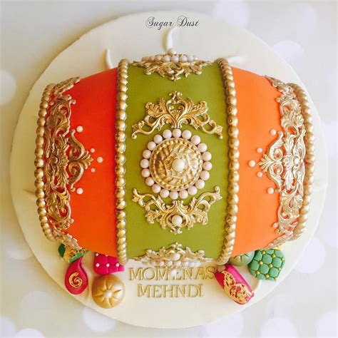 The orange and olive colours of this dholki cake reminds me of an Orla Kiely colour palette # ...