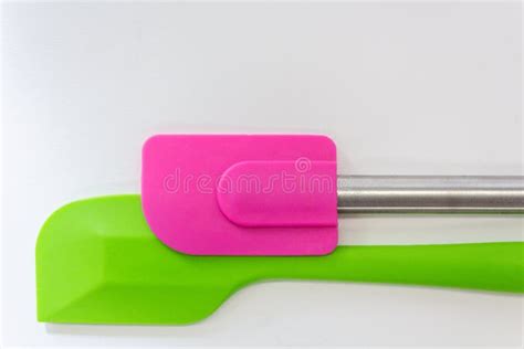 Two Silicone Spatulas, Green And Pink Lay On White Background Stock ...