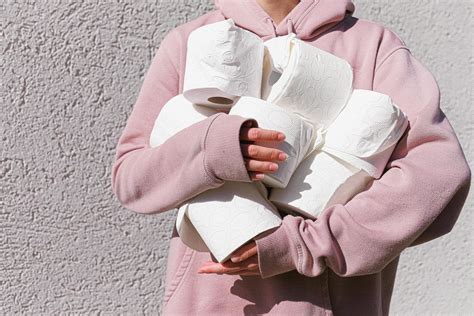 Woman in Pink Long Sleeve Hoodie Carrying Tissue Rolls · Free Stock Photo