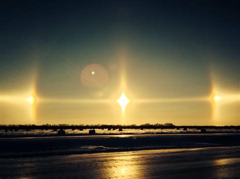 An atmospheric phenomena called sun-dog. The way light refracts through ice crystals in the air ...