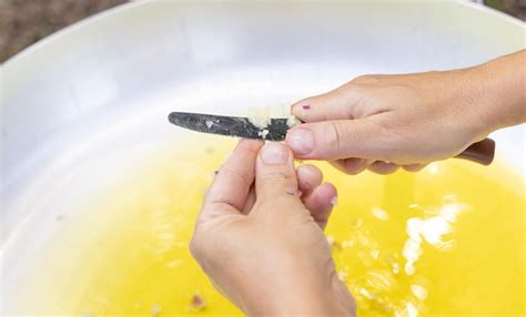 Premium Photo | Woman hands chopping garlic clove over a big frying pan with olive oil close up