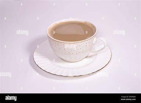 White aesthetic porcelain cup of coffee with beige flowers on white ...