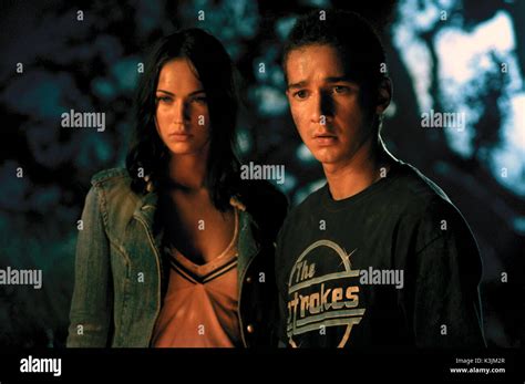 TRANSFORMERS MEGAN FOX as Mikaela Banes, SHIA LABEOUF as Sam Witwicky TRANSFORMERS Date: 2007 ...