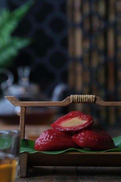 Premium Photo | Close-up of red cake or kue ku on table