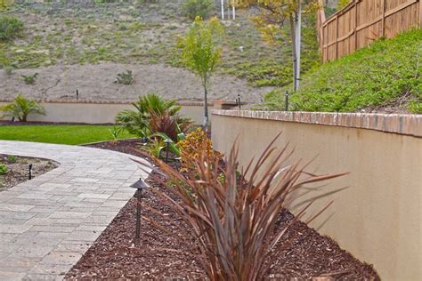 Stucco Retaining Wall Brick Cap | Landscaping retaining walls, Sloped garden, Retaining wall
