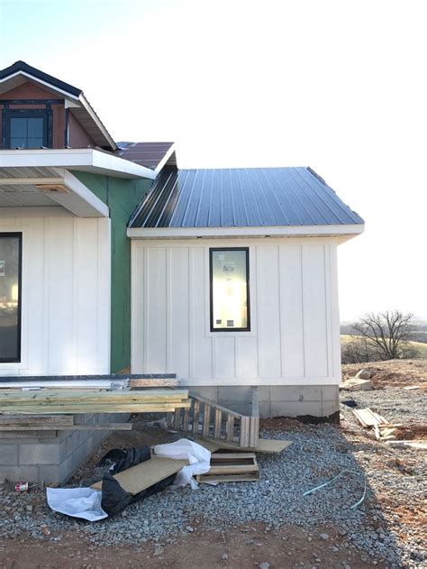 White Board And Batten Smart Siding With Black Metal Roof