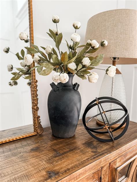 White Flowers In Vase On Wooden Table