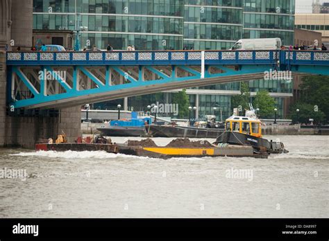 Working River Traffic Under Tower Bridge On The River Thames In Central