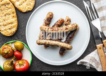 Fast Food Grilled Meat Sausages And Broccoli With Vegetables On Wooden