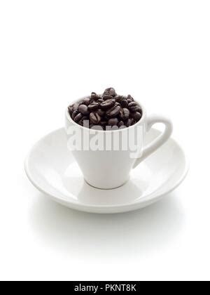 White Cup And Saucer Filled With Coffee Beans Sitting In A Burlap Bag