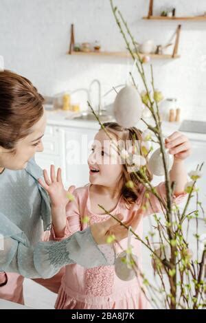 Easter Eggs With Pussy Willow Branches On White Wooden Table Happy