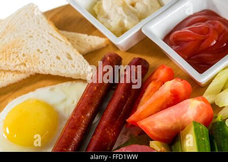 Toasts Fried Eggs Sausages Meat And Vegetables Stock Photo Alamy