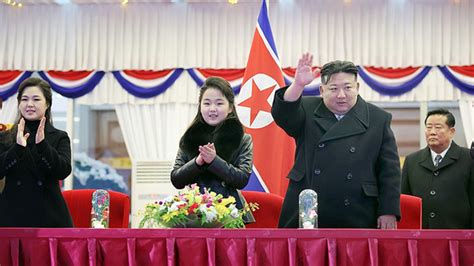 North Korean Leader Kim Jong Un Center Right Waves As He Is