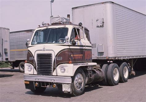 A Large Semi Truck Parked In A Parking Lot Next To Other Semi Trucks