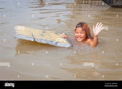 A Young Cambodian Girl Swimming In The Floating Village At Kompong