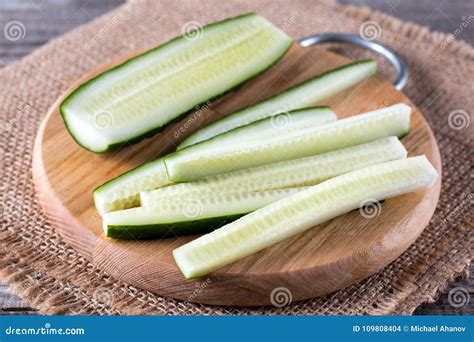 Long Slices of Fresh Cucumber on a Cutting Wooden Board Stock Photo ...