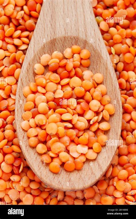 Red Lentils In Wooden Spoon Background Full Frame Stock Photo Alamy