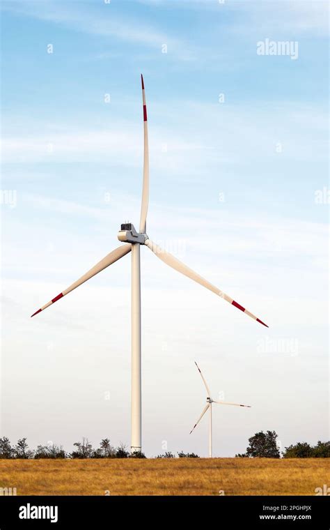 Wind Turbines At Sunset Alternative Energy Concept Several Wind Turbines Stand In A Field And