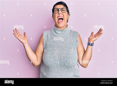 Plus Size Brunette Woman Wearing Casual Clothes And Glasses Celebrating Mad And Crazy For