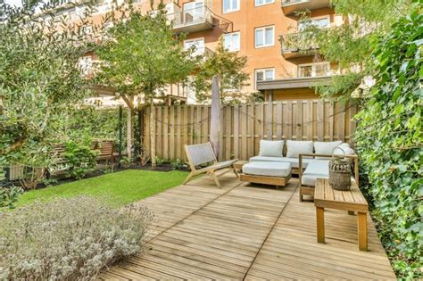 Premium Photo | A backyard with a wooden deck with furniture and a