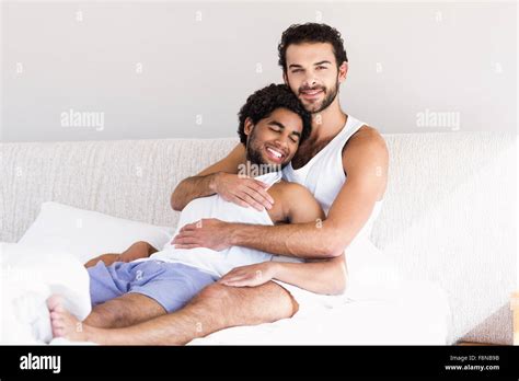 Smiling Gay Couple Hugging On Bed Stock Photo Alamy