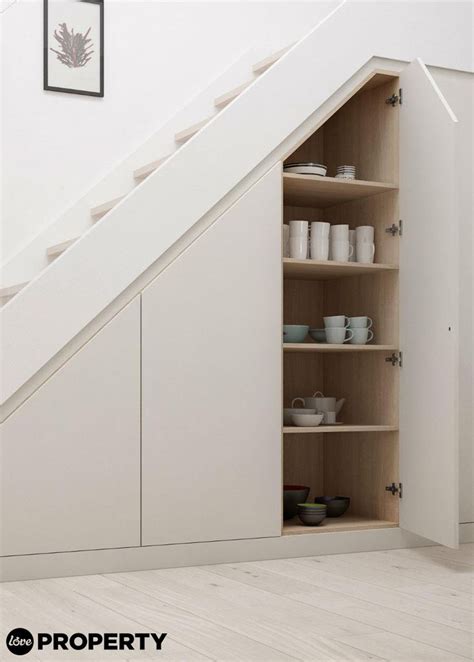 An Open Cabinet Under The Stairs In A Room With White Walls And Wooden