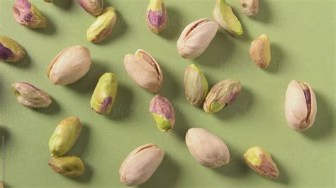 Pistachio Nuts On Green By Stocksy Contributor Kristin Duvall Stocksy