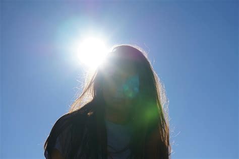 Woman Takes Photo Under the Sun · Free Stock Photo