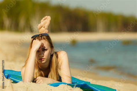 Woman In Bikini Sunbathing And Relaxing On Beach Stock Photo And