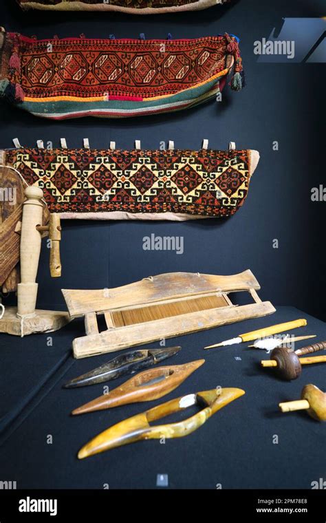 A Display Of Traditional Weaving Loom Tools And Fabrics At The