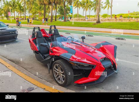 View Of Front Red Polaris Slingshot Parked On Ocean Drive In Miami