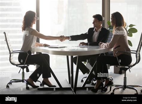 Happy Diverse Business Partners Handshaking At Office Meeting Stock