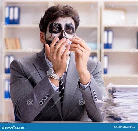 Businessmsn with Scary Face Mask Working in Office Stock Photo - Image