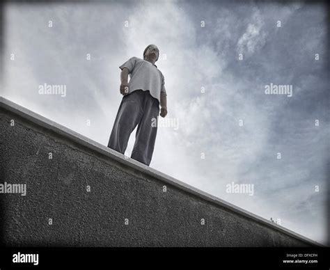 Single man standing on a ledge hi-res stock photography and images - Alamy