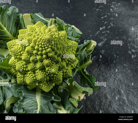 Romanesco Broccoli Head On A Dark Stone Surface Cabbage Close Up