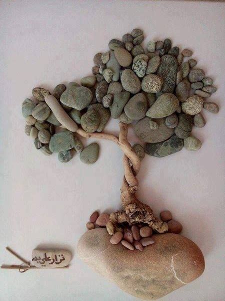 There Is A Tree Made Out Of Rocks And Pebbles On Top Of A Rock Slab