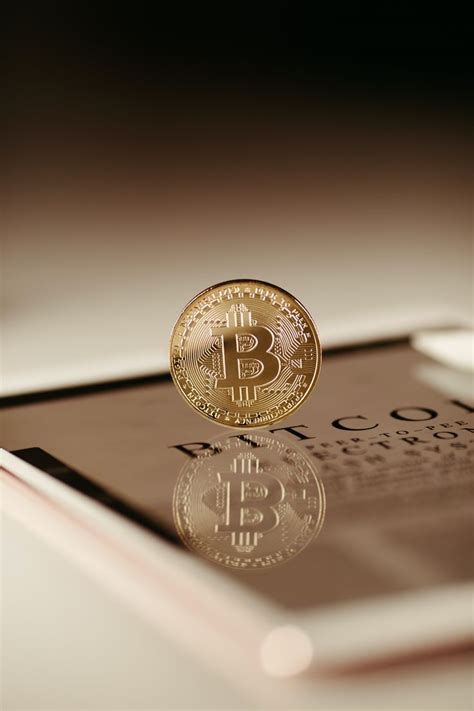 a bit coin sitting on top of an electronic device