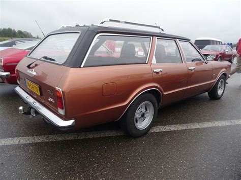 An Old Station Wagon Parked In A Parking Lot