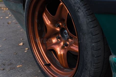 Tuned Green Car On Metallic Burnt Orange Rims Dirty In Autumn Stock