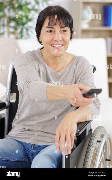 Disabled Woman In Wheelchair Watching Movies At Home Stock Photo Alamy