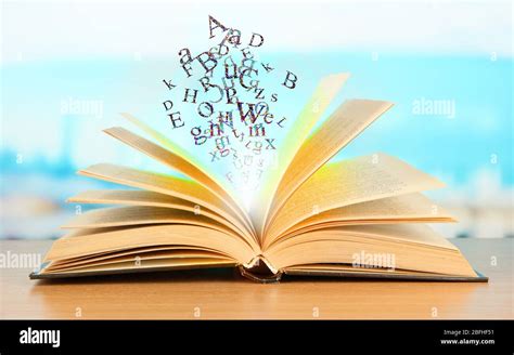 Open Book With Letters On Bright Background Stock Photo Alamy