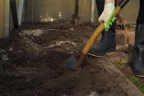 Premium Photo | A man digging a hole with a shovel.