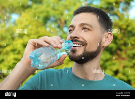 Happy Man Drinking Water Outdoors On Hot Summer Day Refreshing Drink Stock Photo Alamy