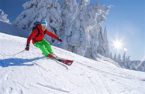 Skier Skiing Downhill In High Mountains Against Cable Lift Stock Image