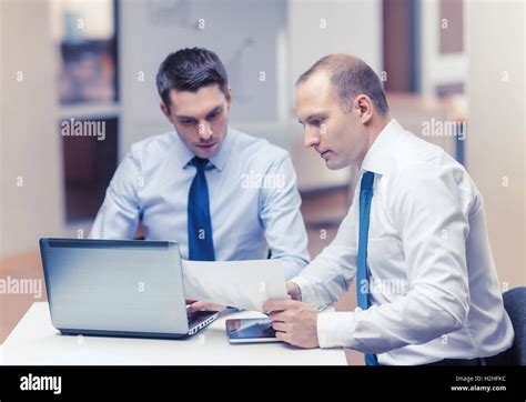 Two Businessmen Having Discussion In Office Stock Photo Alamy