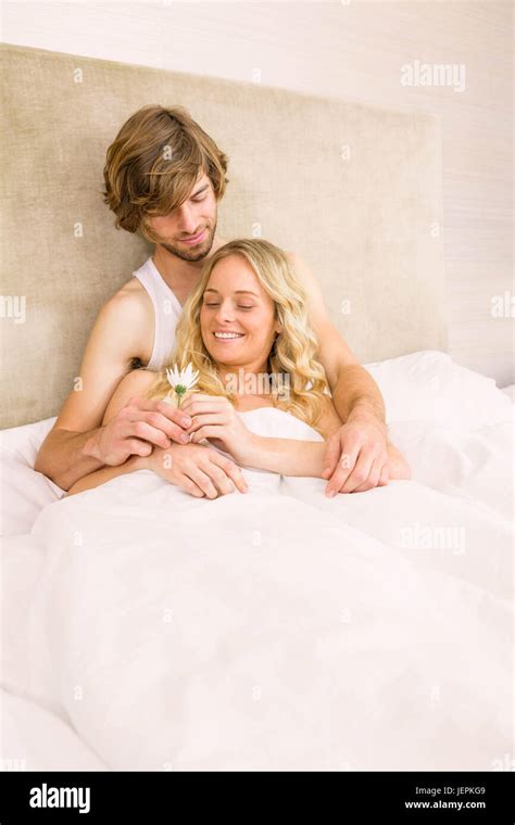 Cute couple cuddling in bed Stock Photo - Alamy