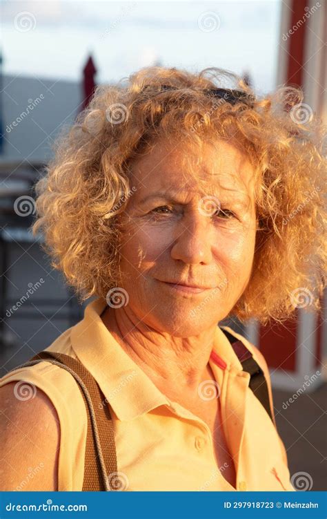 Portrait Of Attractive Senior Woman With Blonde Curly Hair In Sunset Colors Stock Image Image