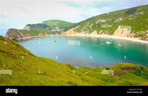 Boats In Lulworth Cove Dorset England Uk With Turquoise Sea Top Tourist