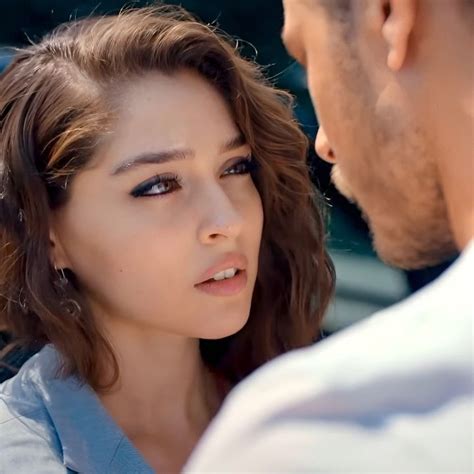 A Man And Woman Looking At Each Other In Front Of A Car With Their Eyes